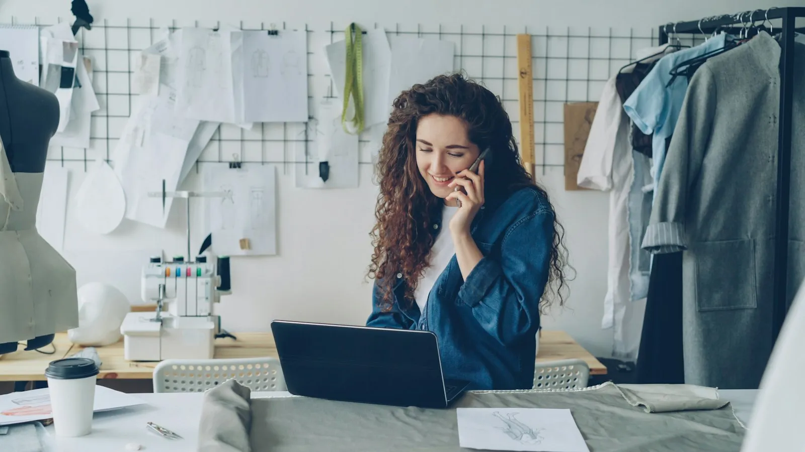 A small business owner working on a laptop in her studio
