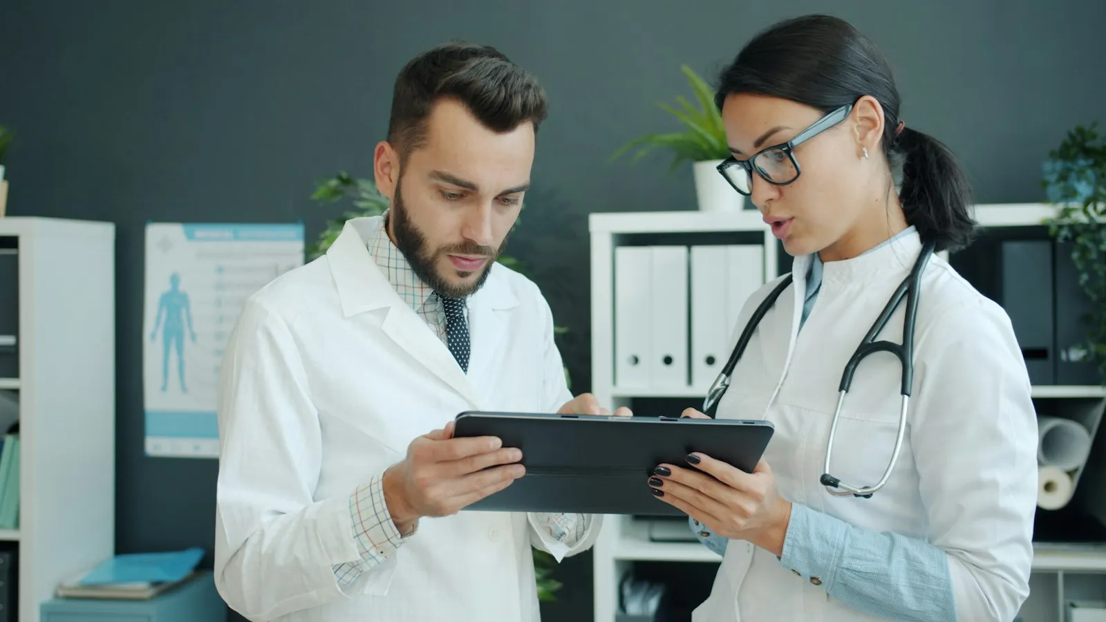 Two doctors reviewing results together on a tablet