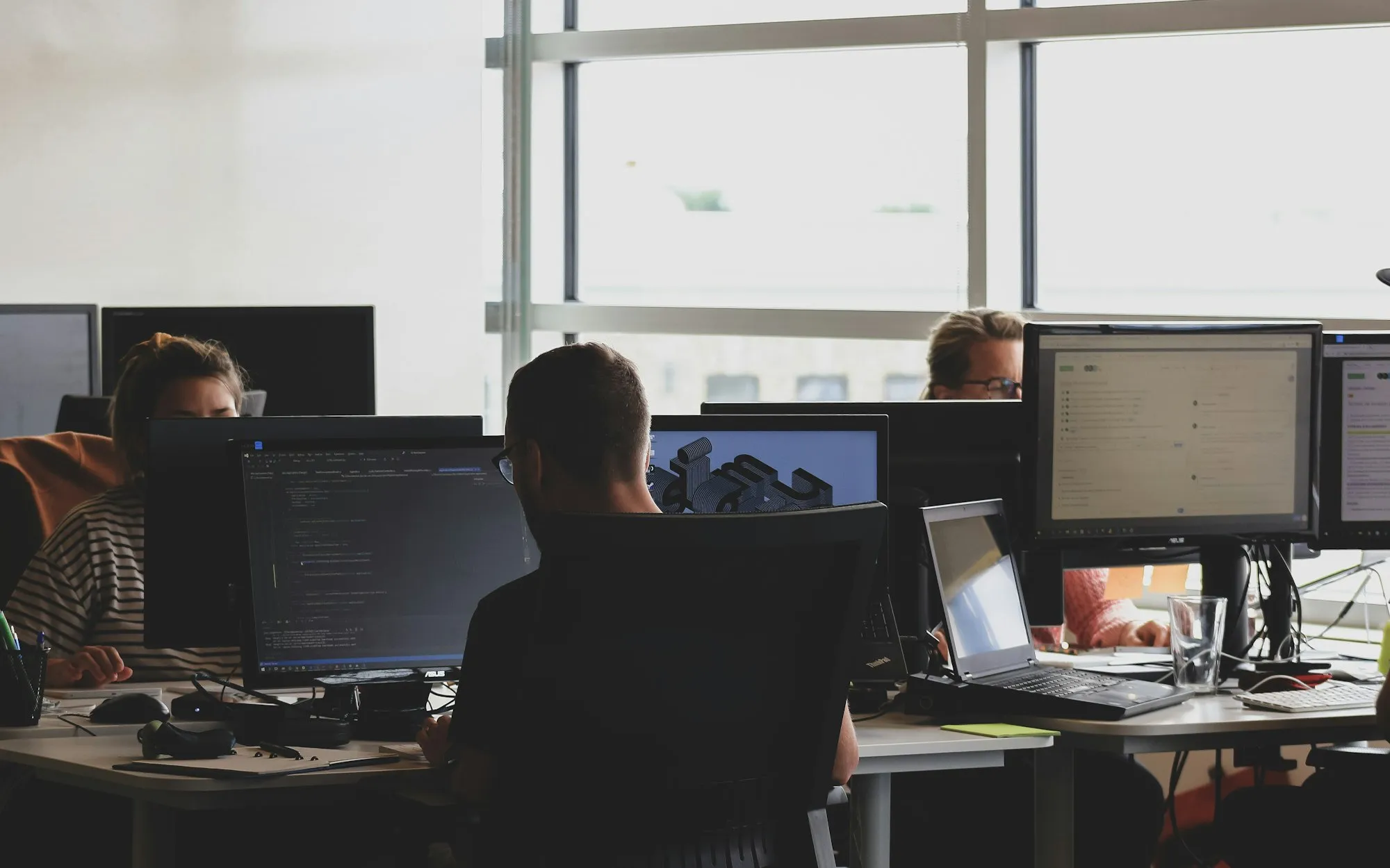 Developers working at monitors in an office