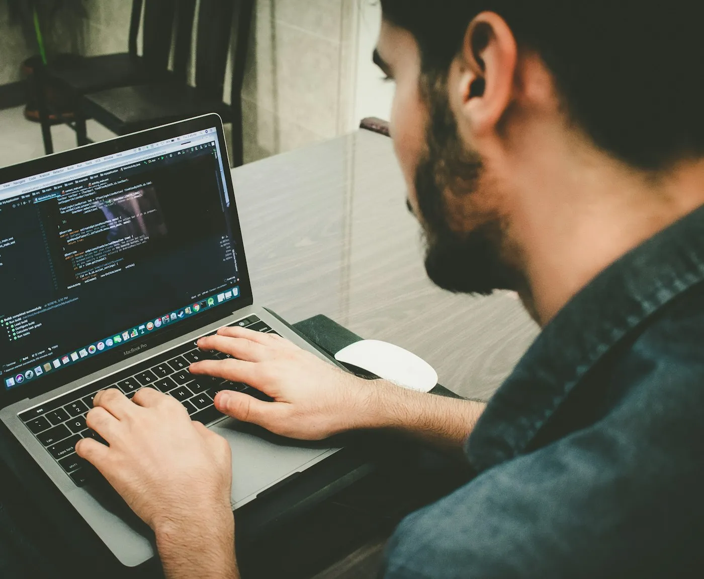 Developer writing code on a laptop