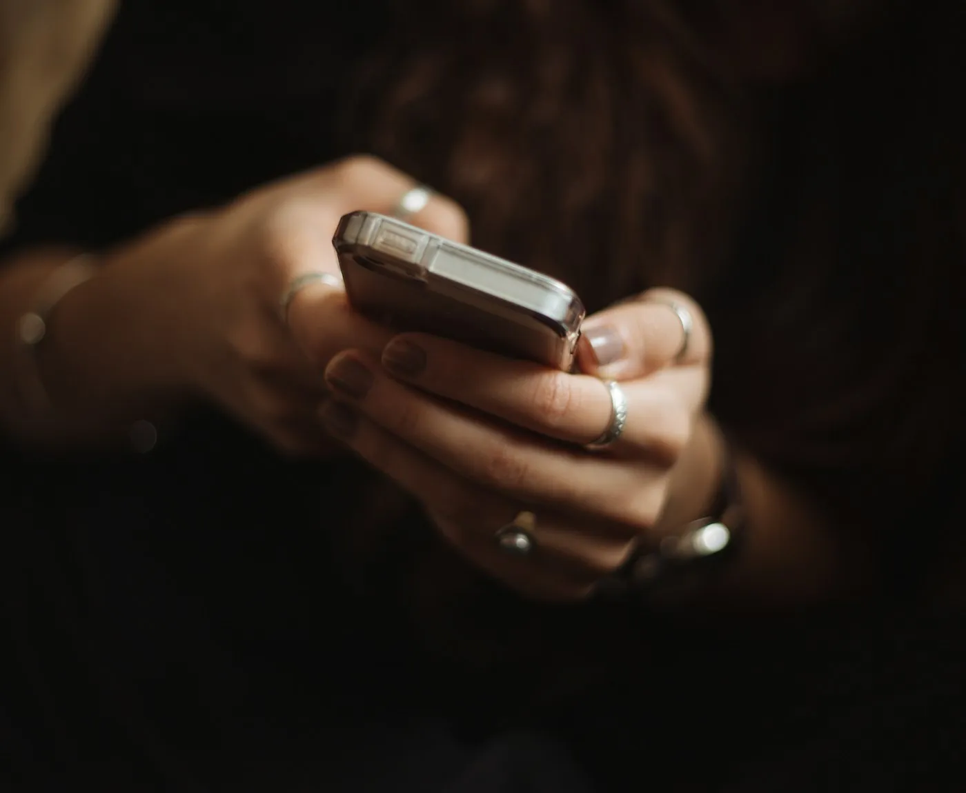 Person holding a smartphone in a dimly lit room